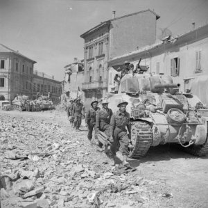 witw T67 Stretcher-bearers-pass-Sherman-tanks-in-Portomaggiore-19-April-1945.jpg